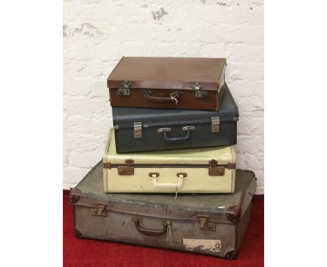 Four old vintage suitcases of various sizes.