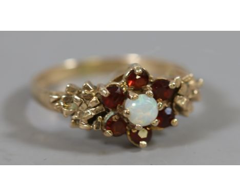 A ladies 9 carat gold garnet and opal cluster ring 3.16 grams, UK size N.