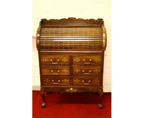A brass inlaid rosewood roll top writing desk raised on cabriole supports.