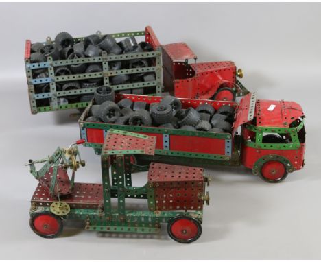 Three vintage Meccano constructed toy lorries along with a collection of 1990 Meccano rubber tyres.