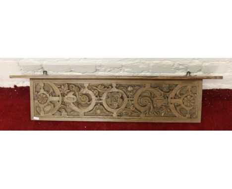 A carved light oak shelf.