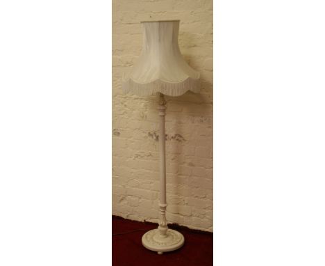 A carved and painted shabby chic standard lamp.