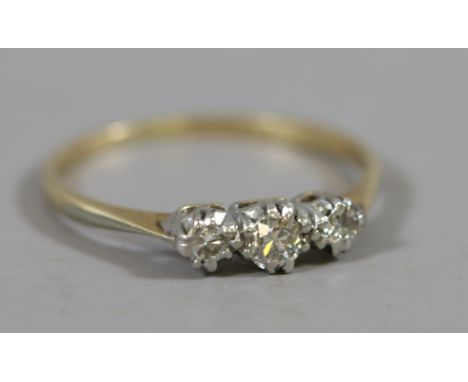 An 18 carat gold and platinum three stone diamond ring, size K.