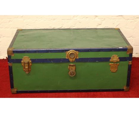 A painted metal travel trunk.