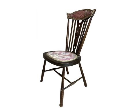 A childs' or dolls' stick back wooden chair with red floral seat. Height approximately 78cm.