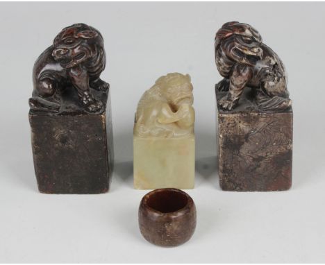 A Chinese archaistic brown jade archer's ring, carved in low relief with a band of scrolls, diameter 3.3cm, together with a g