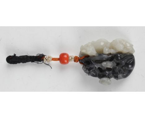 A Chinese carved and pierced pale celadon and mottled grey jade pendant, probably 20th century, designed as two pairs of squi