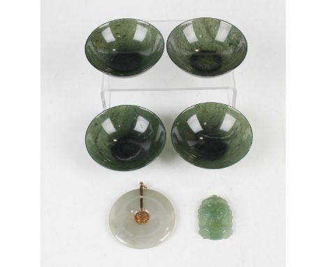A set of four Chinese spinach green jade bowls, early 20th century, each of circular form with carboniferous inclusions, diam