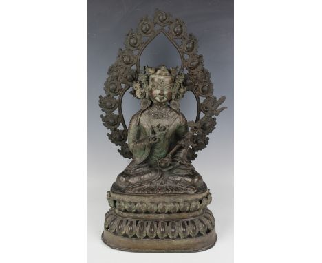 A Sino-Tibetan brown patinated bronze figure of a bodhisattva, Qing dynasty, modelled seated in dhyanasana, wearing a headdre
