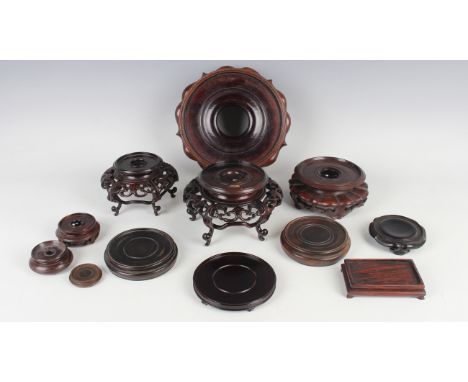 A collection of twelve Chinese hardwood stands, late Qing dynasty and later, including a circular stand with carved apron, di