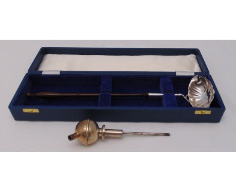 A hallmarked silver punch ladle with double lipped bowl and turned wooden handle by CJ Vander London 1969 in fitted case and 