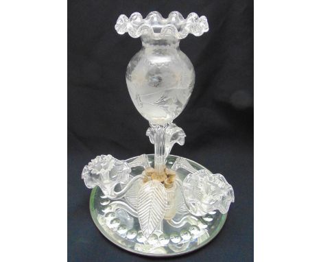 A glass epergne with central ovoid vase on ribbed stem with detachable leaves and flowers all on circular mirrored plateau, 3