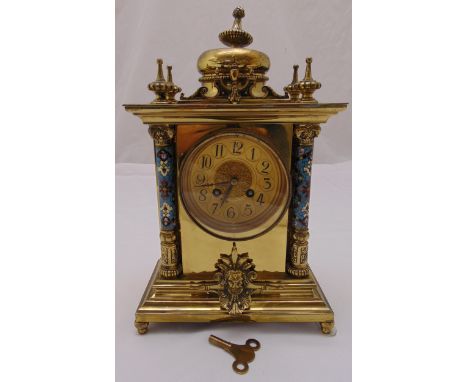 A French rectangular gilt metal mantle clock with gilded dial Arabic numerals and champlevé supporting columns on raised rect