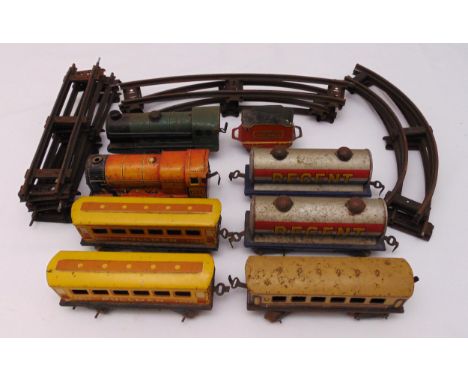 A vintage O gauge litho tin plate wind up train set to include two engines, three coaches, two oil tankers and track, all pla