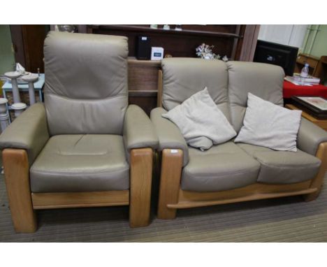 A MODERNIST LIGHT OAK FRAMED TWO-PIECE SUITE, with field mushroom coloured leather upholstery, the single chair being a manua