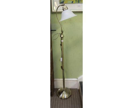 A MODERN BRUSHED BRASS FINISHED FLOOR STANDING LAMP with opaque glass shade 