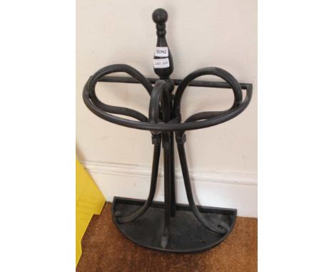 A BLACK PAINTED METAL DEMI-LUNE STICK STAND 