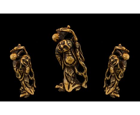 Netsuke. Late 18th century Japanese stags horn netsuke carving depicting a diety of fine patternation and wear consistent wit