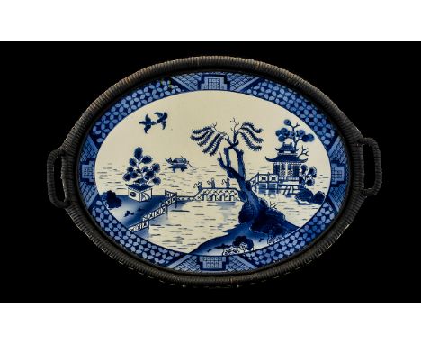 An Early 20thC Twin Handled Tray with a blue and white ceramic plaque, blue and white pagoda pattern with three figures on a 