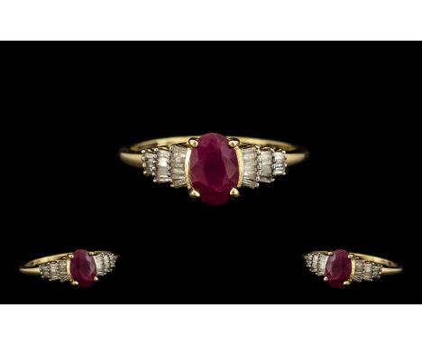 Ladies 9ct Gold Contemporary Ruby and Diamond Set Dress Ring marked 9.375. The central oval shaped ruby of good cololur. Ring