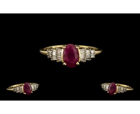 Ladies 9ct Gold Contemporary Ruby and Diamond Set Dress Ring marked 9.375. The central oval shaped ruby of good cololur. Ring