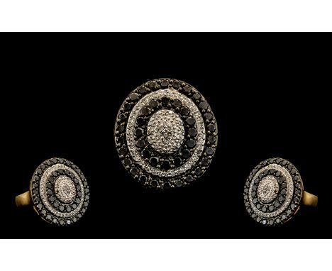 Ladies Attractive Contemporary Oval Shaped Cluster Ring set with black and white diamonds in a flowerhead setting.  Ring size