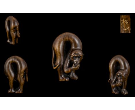 A Japanese Boxwood Netsuke - In The Form Of A Monkey Eating Fruit. Signed To Back Of Leg. Height 5cm. Please See Accompanying