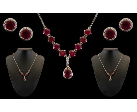 Boxed Set of Silver Necklace &amp; Earrings set with ruby coloured stones and crystal decorative stones.  Earrings are for pi