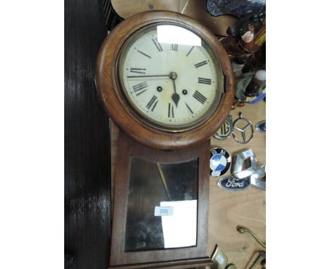 An oak case all clock with glass door and Roman numerals to enamel face.