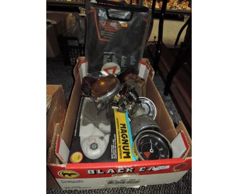 A box of vintage car or bike speedometers, gauges, tail lights and more.