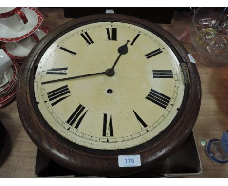 An oak cased wall clock having enamel face and Roman numerals.