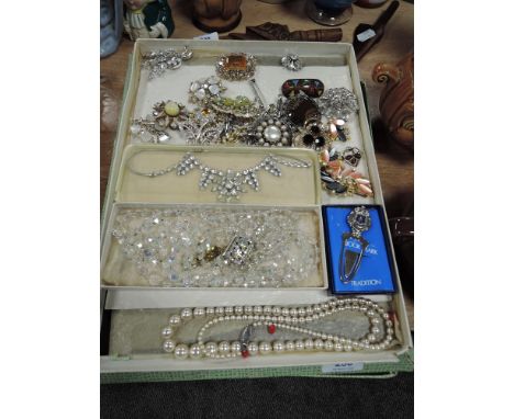 A box of vintage costume jewellery including Faceted glass necklace,brooches and more.