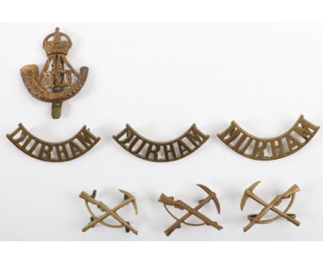 WW1 Durham Light Infantry Badge Grouping, including all brass cap badge, shoulder titles and pioneer crossed rifle and pick c