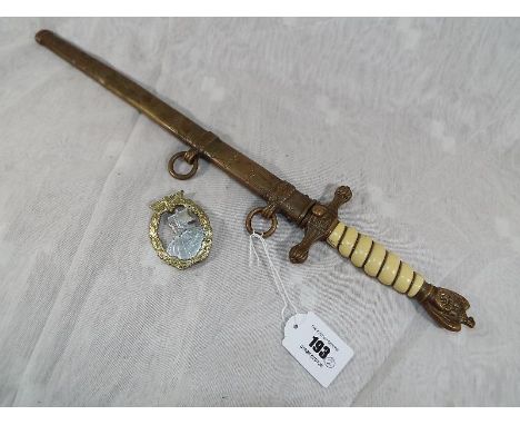 An original German World War Two (WWII) Kriegsmarine dagger with brass scabbard, the blade marked ORIGINAL EICKHORN SOLINGEN 