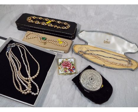 A Stratton powder compact, a small compact mirror and a collection of pearl necklaces and similar