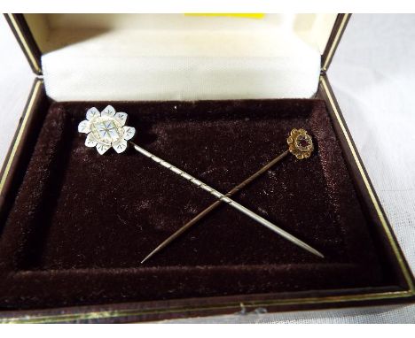A lady's 9ct gold hallmarked tie pin, set with ruby and one other of white metal (2)