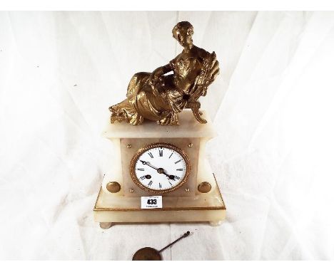 An alabaster mantle clock with relief decoration of a reclining lady, with bell striking and pendulum, 30cm (h) x 20cm (w) - 