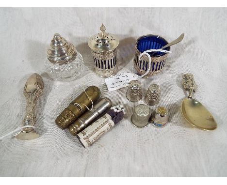 An Edwardian silver hallmarked salt seller and pepper pot Birmingham assay 1902, a silver topped cut glass pepper pot, a silv