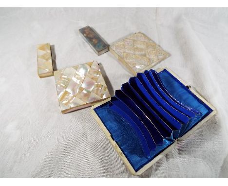 Two place card holders with hinged lids, finished with mother of pearl and a good quality card holder with hinged opening, si