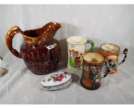 A good mixed lot of ceramics comprising an Arthur Wood Hound Handle water jug, two Sandland jugs, a Crown Devon Fieldings jug