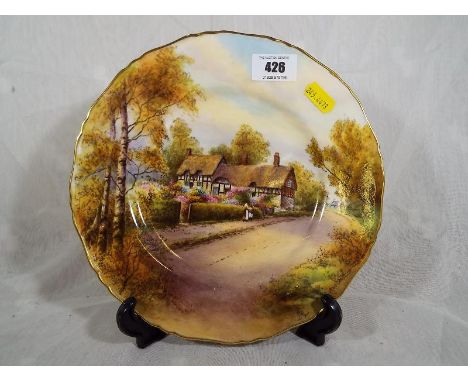 A Royal Worcester Cabinet plate entitled ' Ann Hathaway's Cottage', with gilt edge black factory marks to the base, 26cm (dia