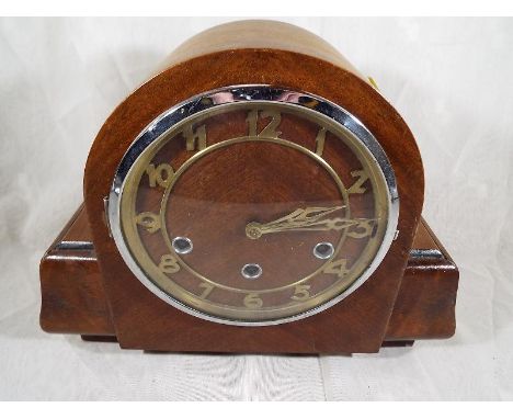An Art Deco style mantel clock, oak case with applied skeletonised chapter ring and chrome bezel, Westminster chime movement 