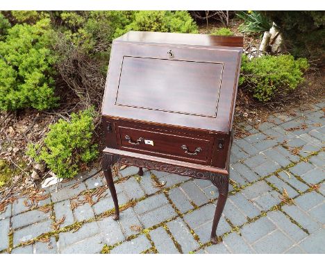 An early to mid 20th century small mahogany bureau with slope front opening to reveal a fitted pigeon-hole interior, manual l