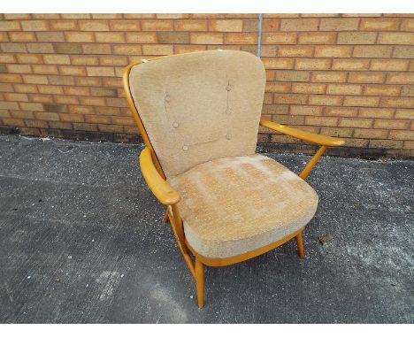 An Ercol light-wood arm chair with loose upholstery