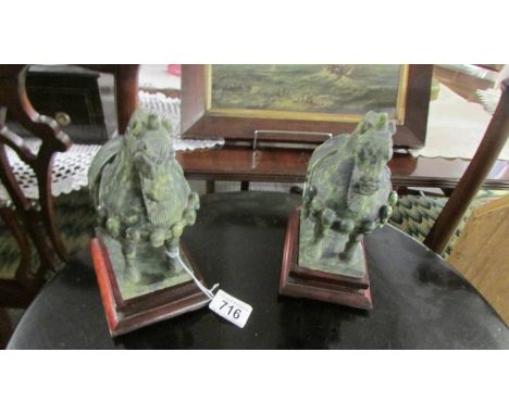 A pair of jade horses on stands.  