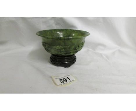 A small carved jade bowl on stand. 12.5cm diameter.  