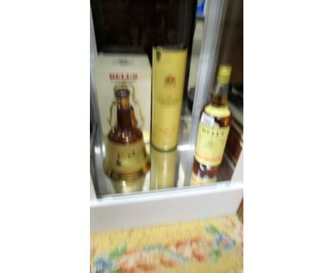 A bottle of Glenlivet 10yr malt, a bottle of Bell's Scotch whisky &amp; A Bell's whisky bell with contents. Collect only.  