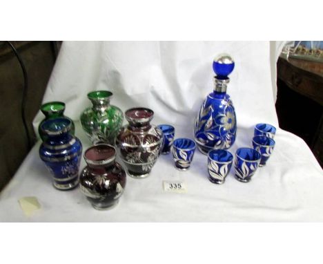 Five coloured glass vases decorated with silver and a blue glass decanter with 6 glasses also decoated with silver. Collect o