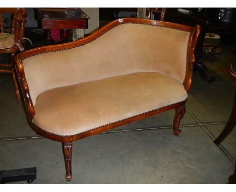 A mahogany framed Victorian sofa in beige.  