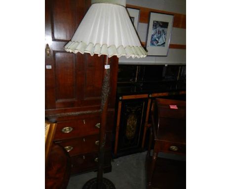 A carved wood standard lamp with shade.*condition report*In good condition, shade shows signs of age but also in good conditi